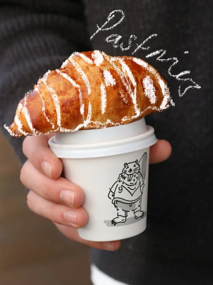 Branded coffee cup and croissant